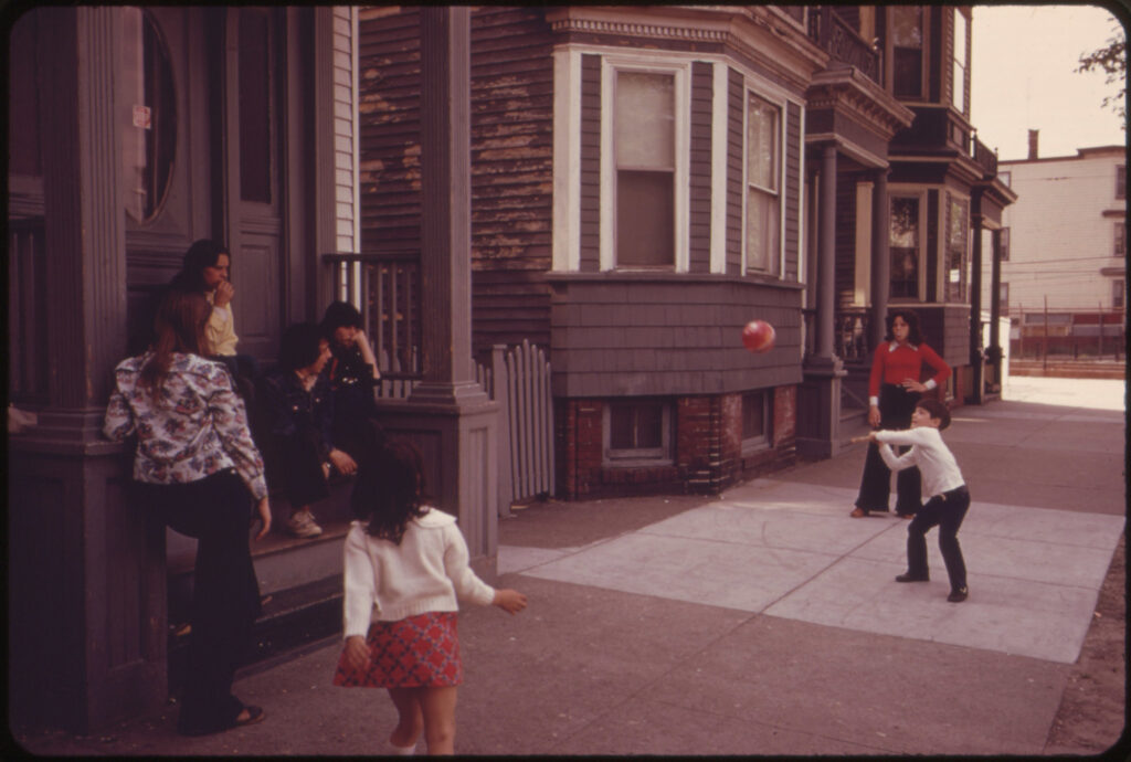 A film photo of children playing stickball in East Boston